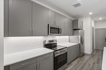 Shaker or slab kitchen cabinetry with under-cabinet lighting